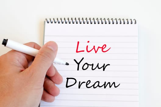 Live your dream text concept write on notebook