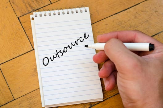 Outsource text concept write on notebook