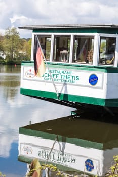 Essen Kettwig,Nrw,Germany - April 28,2016:. Stern of the café and restaurant Schiffe Tetris in the city of Essen district Kettwig at the reservoir. The Thetis has been anchored directly in front of the weir since 1950.