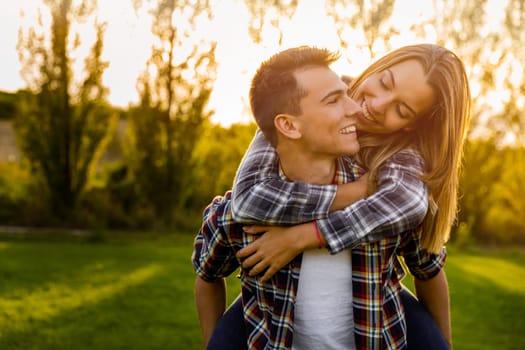 Portrait of a happy young couple in the nature hugged together