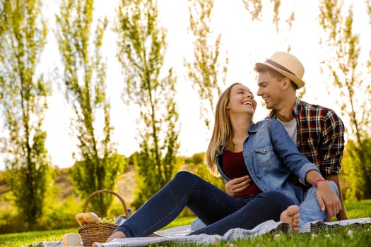 Shot of a happy couple enjoying a day in the park making a picnic