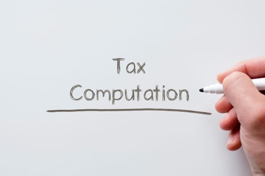 Human hand writing tax computation on whiteboard
