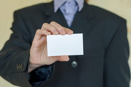 Business woman hand holding white empty note..