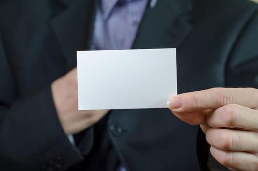 Business woman hand holding white empty note..