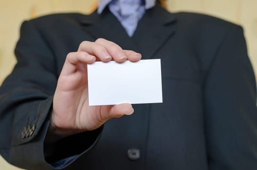 Business woman hand holding white empty note..