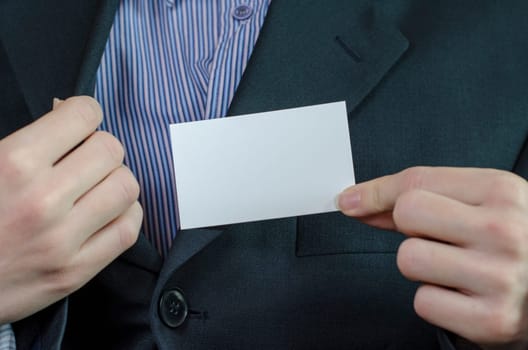 Business woman hand holding white empty note..