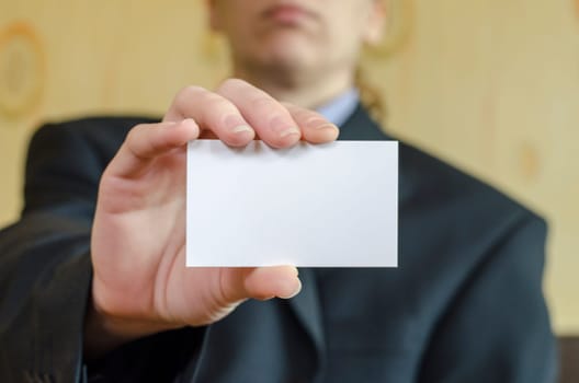 Business woman hand holding white empty note..