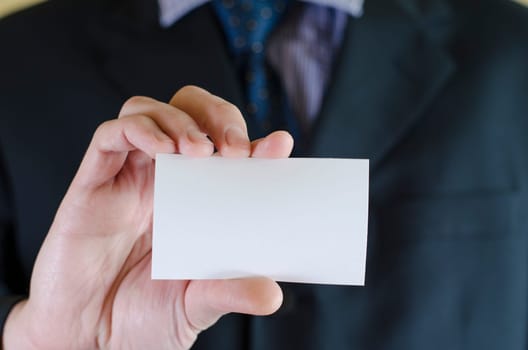 Business man hand holding white empty note..