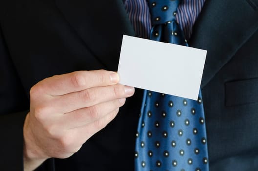 Business man hand holding white empty note..