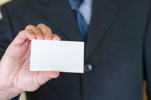 Business man hand holding white empty note..
