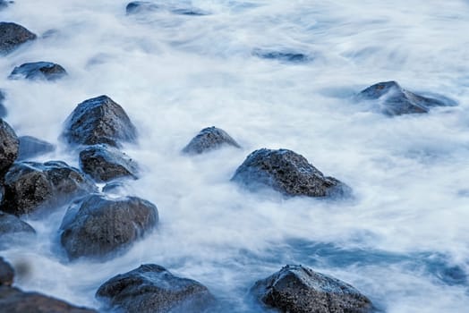 Surf of the Atlantic Ocean with rocks in long exposure
