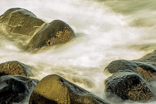 Surf of the Atlantic Ocean with rocks in long exposure