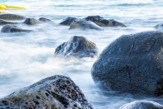 Surf of the Atlantic Ocean with rocks in long exposure