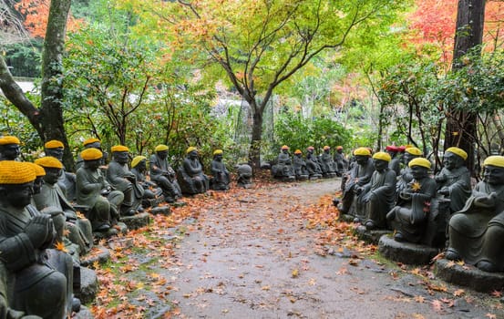 Autumn Japanese garden with Buddha lined up pathways at Daisho-in Temple grounds in Miyajima Island, Hiroshima, Japan