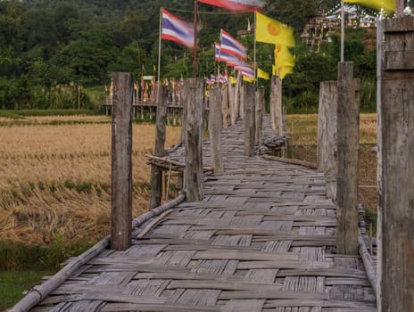 Beautiful view of Zu Tong Pae bamboo bridge pass rice field to the temple in Mae Hong Son, Thailand
