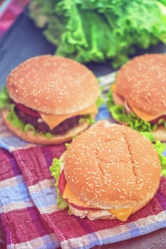 Closeup of home made burgers on wooden table