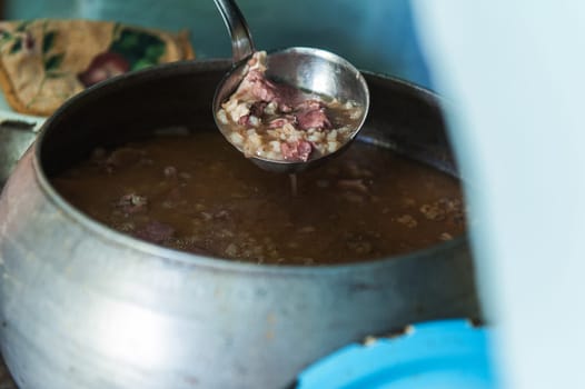 Cooking meals in a Russian stove, soup with meat and groats