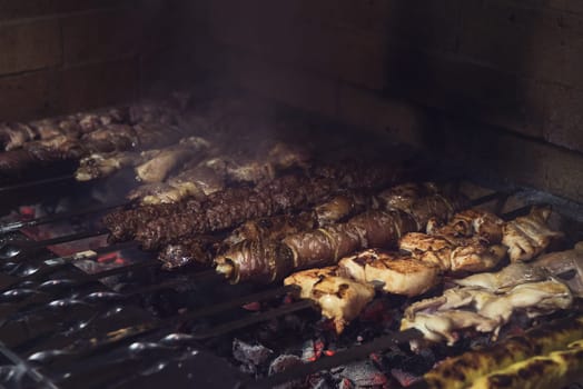 Grilling marinated shashlik on a grill
