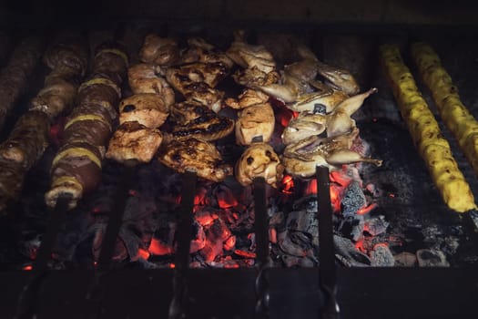 Grilling marinated shashlik on a grill