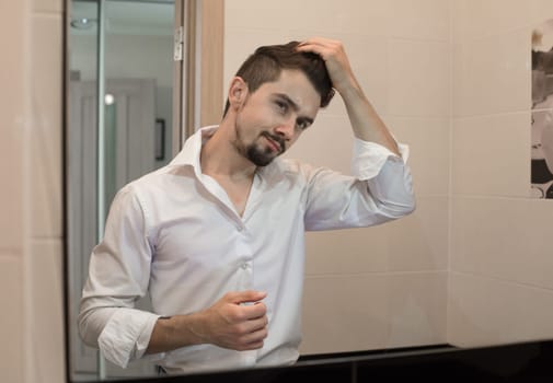 Handsome man care about hair
