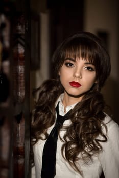 Amazing,seductive,beautiful girl in school uniform stand in bar. Sexual,seductive,attractive,excellent,perfect student,school girl,teacher with beautiful make-up,red lips,wavy,curly hair in bar.