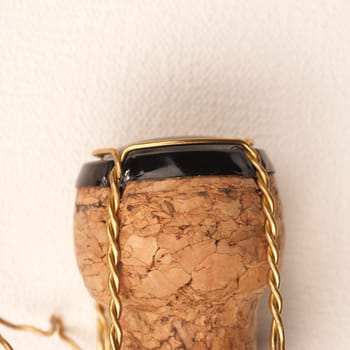 Champagne bottle cork on a white fabric, close up shot
