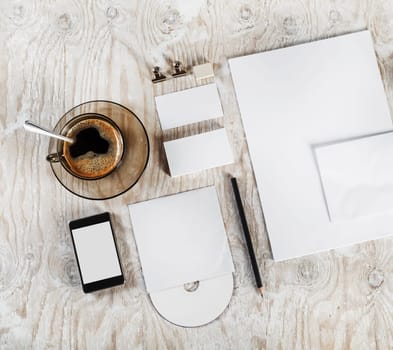 Photo. Blank stationery and corporate identity set on light wooden table background. Template for ID. Blank objects for placing your design. Top view.