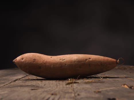 Fresh batata on an old rustic wooden table
