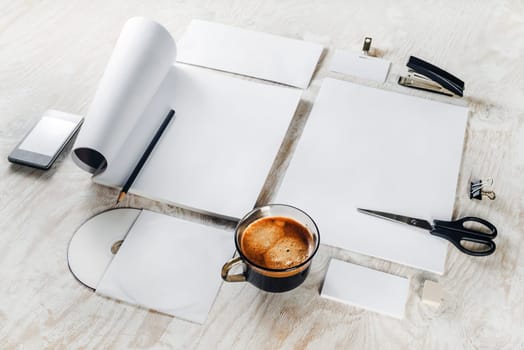 Blank stationery and corporate id template on light wooden table background. Blank objects for placing your design.