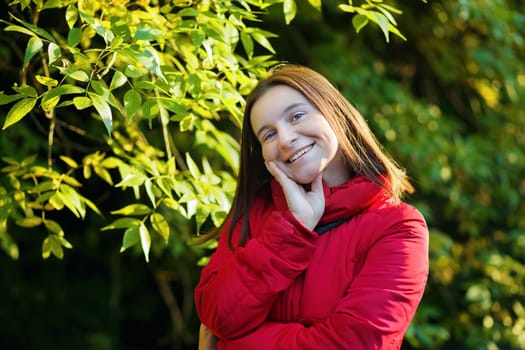 Smiling woman in a red jacket. Selective focus.