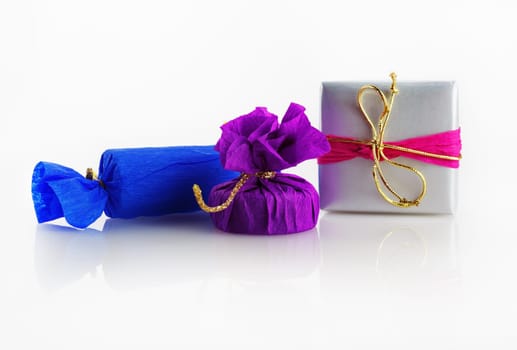 Bright colorful gift boxes with decorative ribbons and bows on a light background.