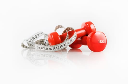 Dumbbells and measuring tape. Fitness concept. Composition on the theme of healthy lifestyles.
