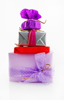 Christmas gifts with decorative ribbons and bows. Colorful gift boxes on a light background.