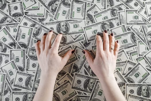 Female hands and money. Top view.
