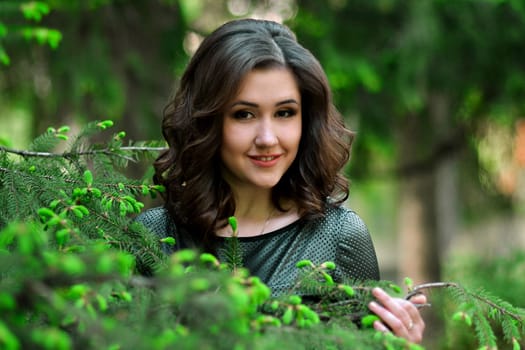 Beautiful attractive smiling cute lovely kind awesome gorgeous excellent girl,model in the fresh,green,spring garden,park,forest.Spring time.Portrait of beautiful girl in spring,green blossom garden.Gorgeous,attractive,beautiful,pretty,nice cute girl