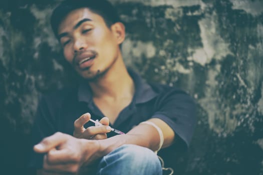 drug addict man with syringe in action
