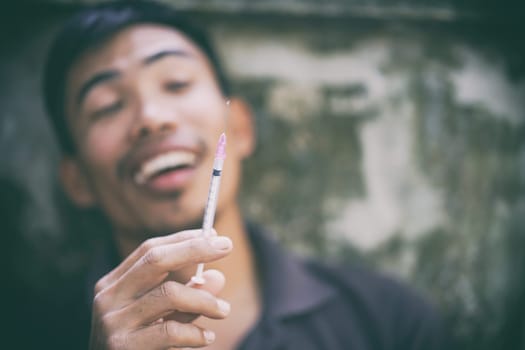 drug addict man with syringe in action