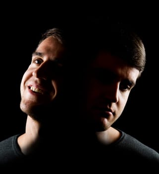 Double exposure of a young man in partial shade. Radiating joy on the left  on the right with a sad expression.