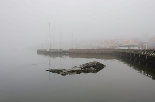 fog on the swedish westcoast the boat is in the harbour