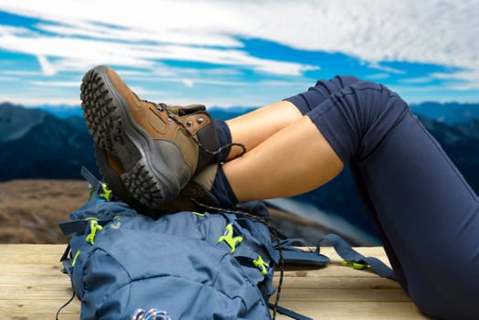 Hiking equipment, rucksack, boots and backpack. Concept for family hiking. Colorful background. Focus on the boots.