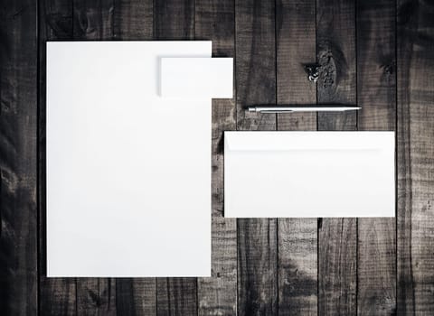 Blank letterhead, business cards, envelope and pen on vintage wooden table background. Blank stationery template for branding identity . Mockup for placing your design. Top view.