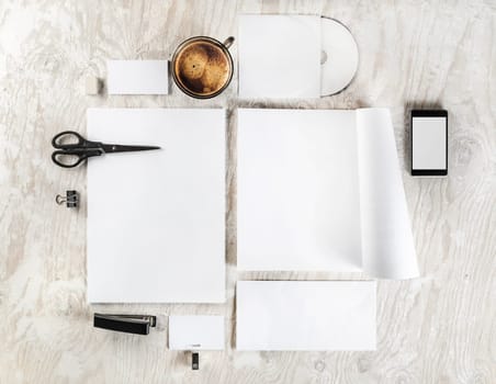 Photo of blank stationery and corporate identity template on light wooden table background. Mock up for branding identity. Responsive design mockup. Blank ID objects for placing your design. Top view.
