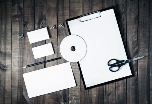 Blank stationery and corporate identity template on vintage wooden background. Responsive design mock up. Blank objects for placing your design. Top view.