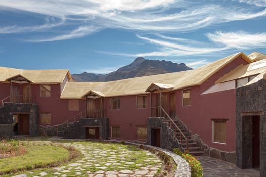 CHIVAY, AREQUIPA, PERU - NOVEMBER 25, 2015: A traditional vintage hotel in Chivay, Arequipa Peru with mountains and blue sky.