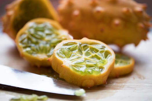 Slices of kiwano fruit with knife.