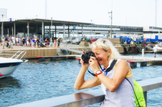 Woman photographs on the quay