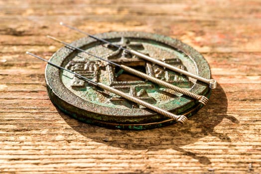 Acupuncture needles on Chinese,antique coin