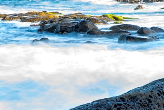 Surf of the Atlantic Ocean with rocks in long exposure