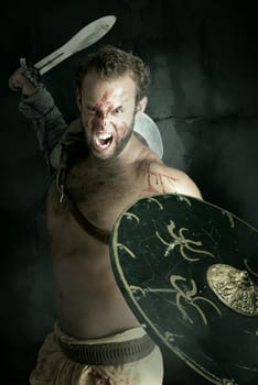 Ancient warrior or Gladiator posing against a dark background with sword