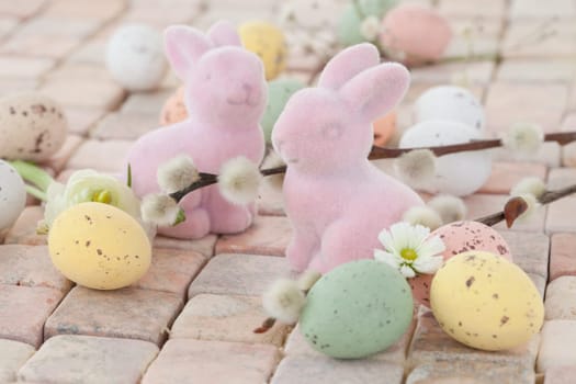 Little pink Easter bunnies and colorful Easter eggs